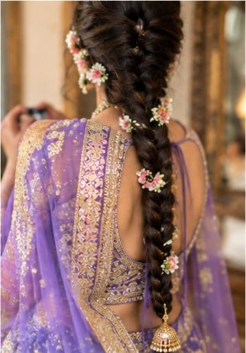 A bridal braid dressed with fresh flowers