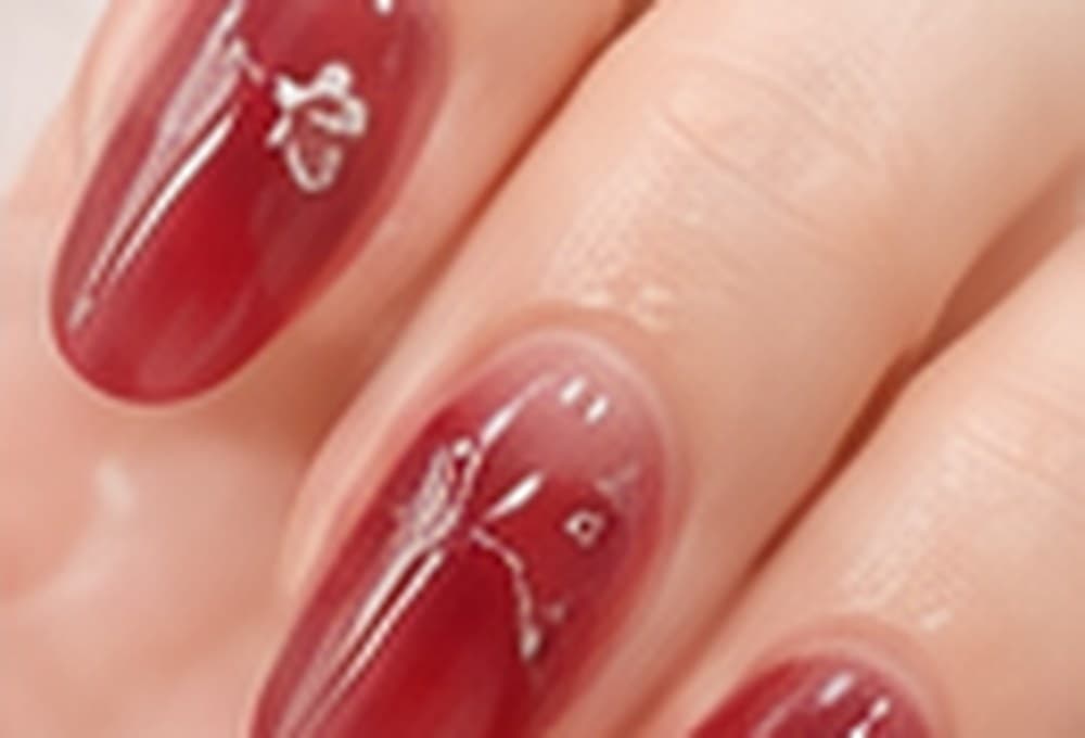 Long nails in a deep cherry red finish with fine line art