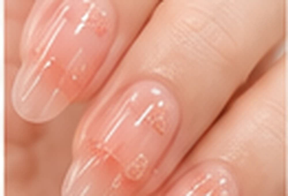Nails in a warm, see-through peach jelly finish