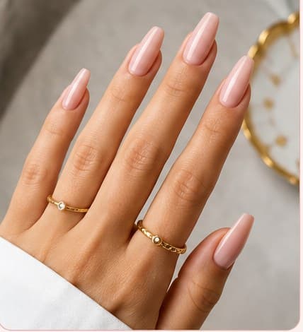 Long coffin-shaped nail extensions in a pale pink finish