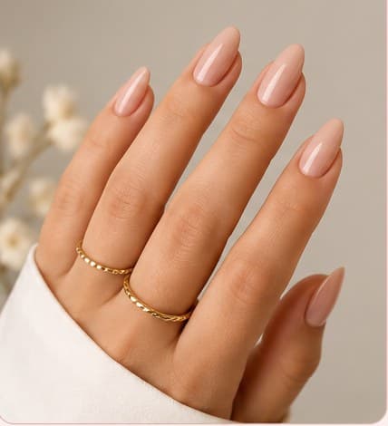 Medium-length almond nail extensions in a soft nude shade