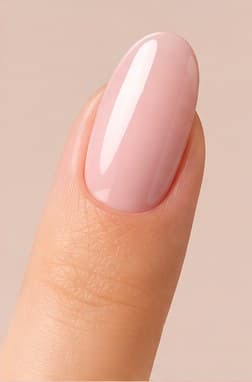 Oval-shaped nail extension in a sheer pink finish